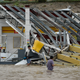 People walk next to a gas station flooded and damaged by the impact of Hurricane Maria in Puerto Rico. (Image: AP)